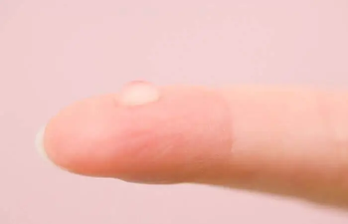 finger with a water droplet on it