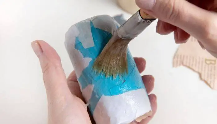 applying waterproof glue to paper mache