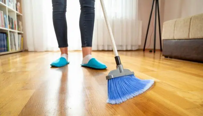 brushing dirt off laminate floor
