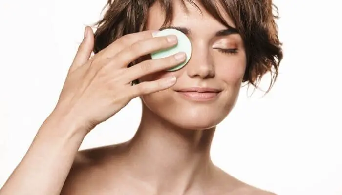 woman using makeup remover