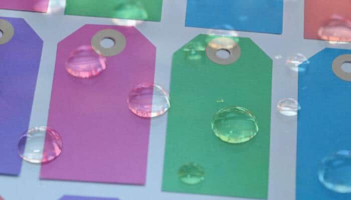 multicolored labels with water droplets on them